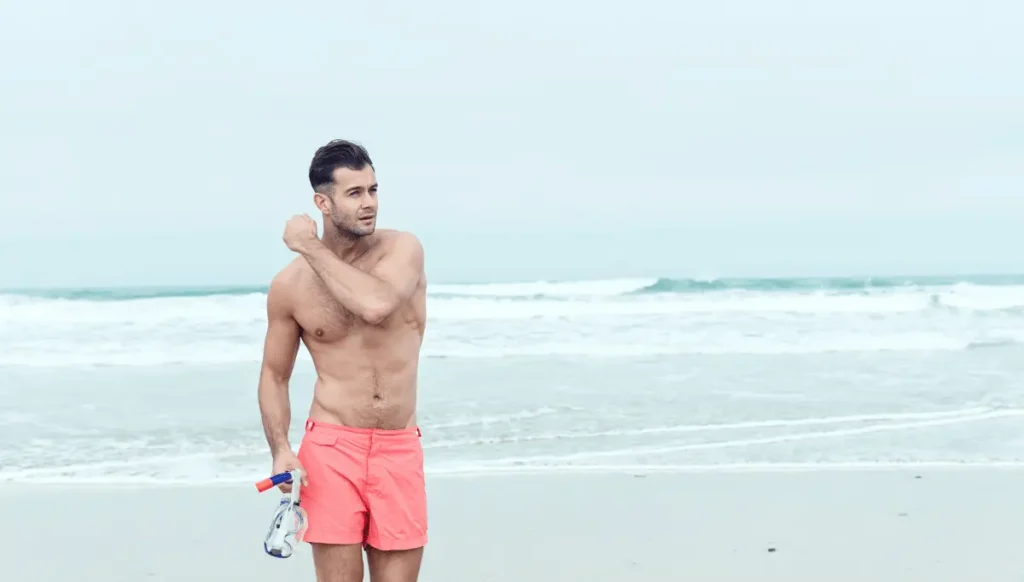 a man swimming in shorts